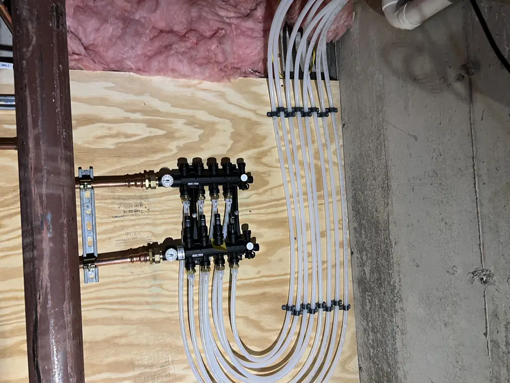 Radiant heating manifold with color-coded loops and circulator piping